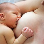 13153684 – mother breastfeeding her five days old baby
